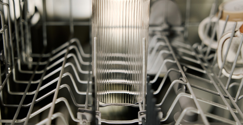 Glassware clean on top of dishwasher rack.